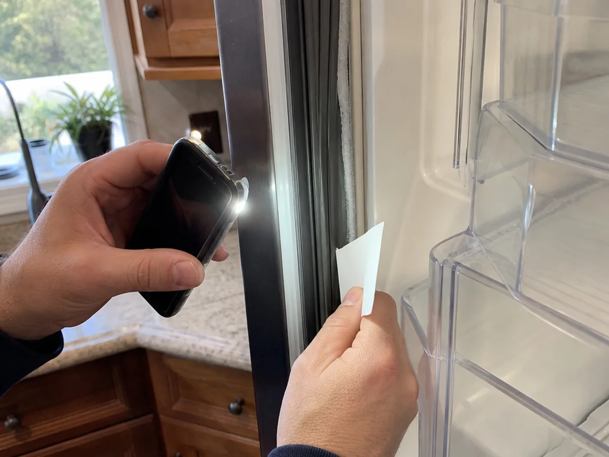 Novato Sub-Zero door gasket compression test with flashlight and paper slip